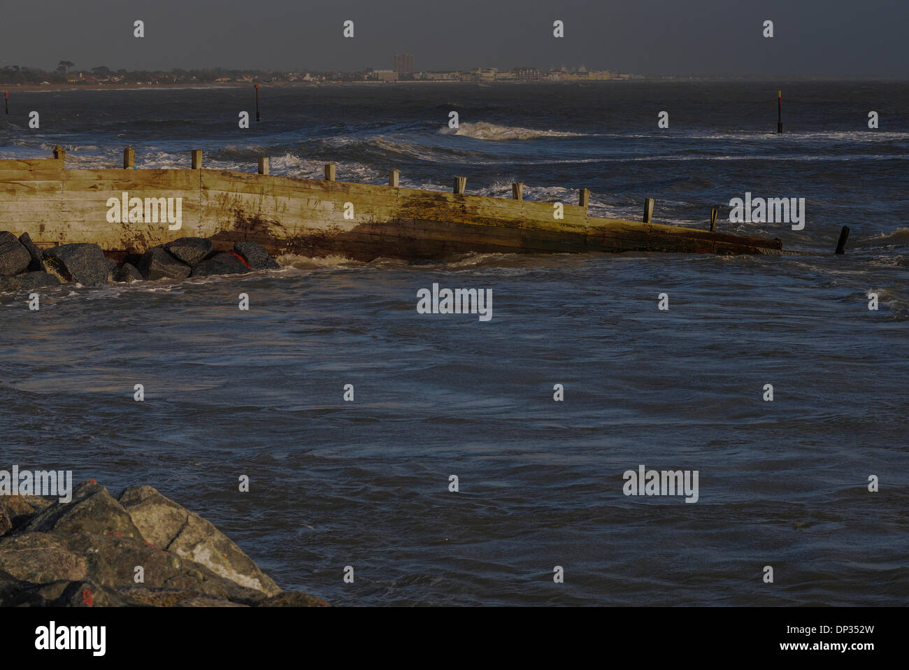 Pagham, West Sussex, UK. 7th January 2014. Large rocks from the tidal defense have fallen into the sea. One concerned resident said ' The sand is washing away from beneath the rocks and they are rolling into the sea'. This picture shows the swirling tide and part of the tidal rock defenses on the left. Credit:  David Burr/Alamy Live News Stock Photo