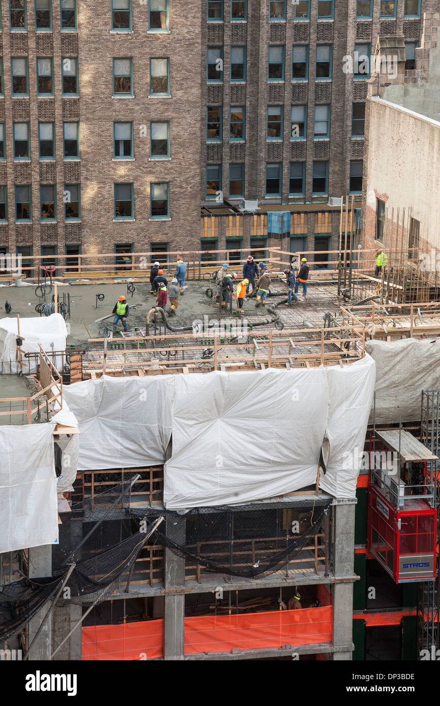 High-rise Building Construction Site with tradesmen, NYC,USA Stock Photo