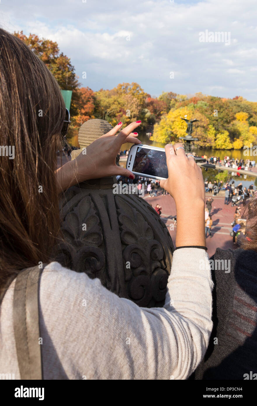 Female Tourist Photographing Activity in Central Park, NYC, USA Stock Photo