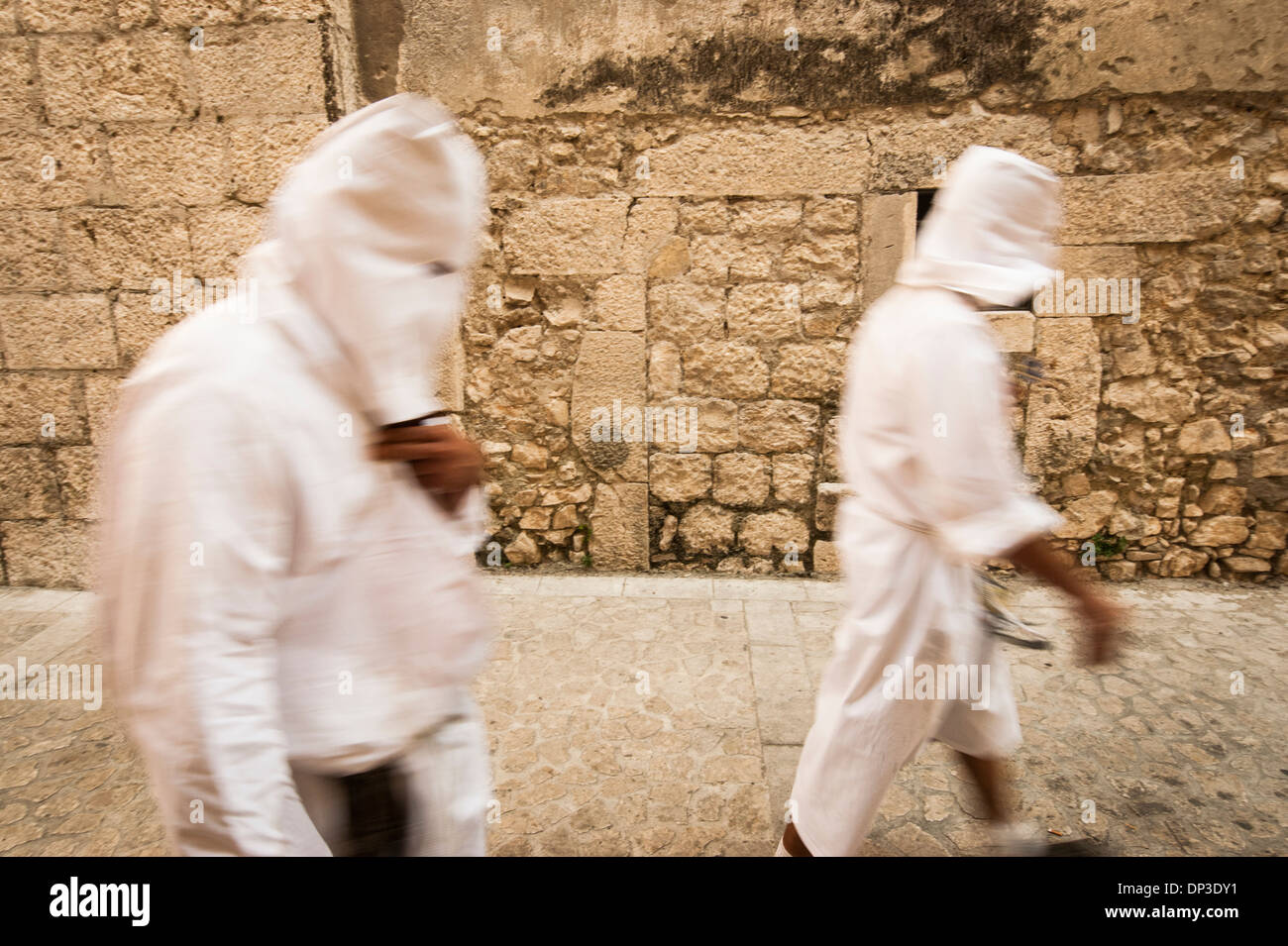 Penitents leaving the bloody procession for the Assumption of the Virgin Mary in Guardia Sanframondi, Campania, Italy Stock Photo