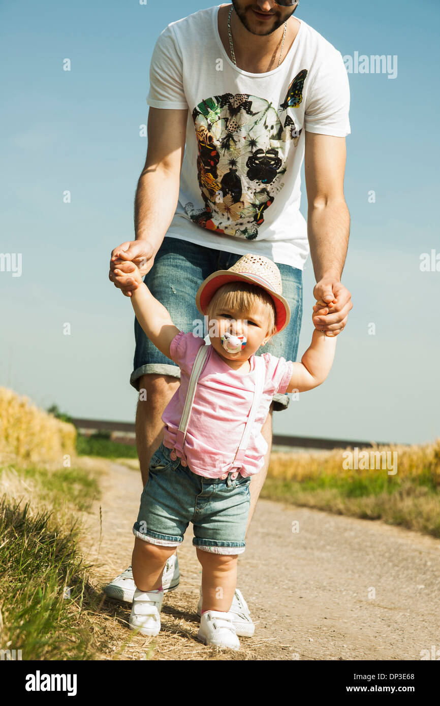 Father and Baby Daughter Walking Outdoors, Mannheim, Baden-Wurttemberg, Germany Stock Photo