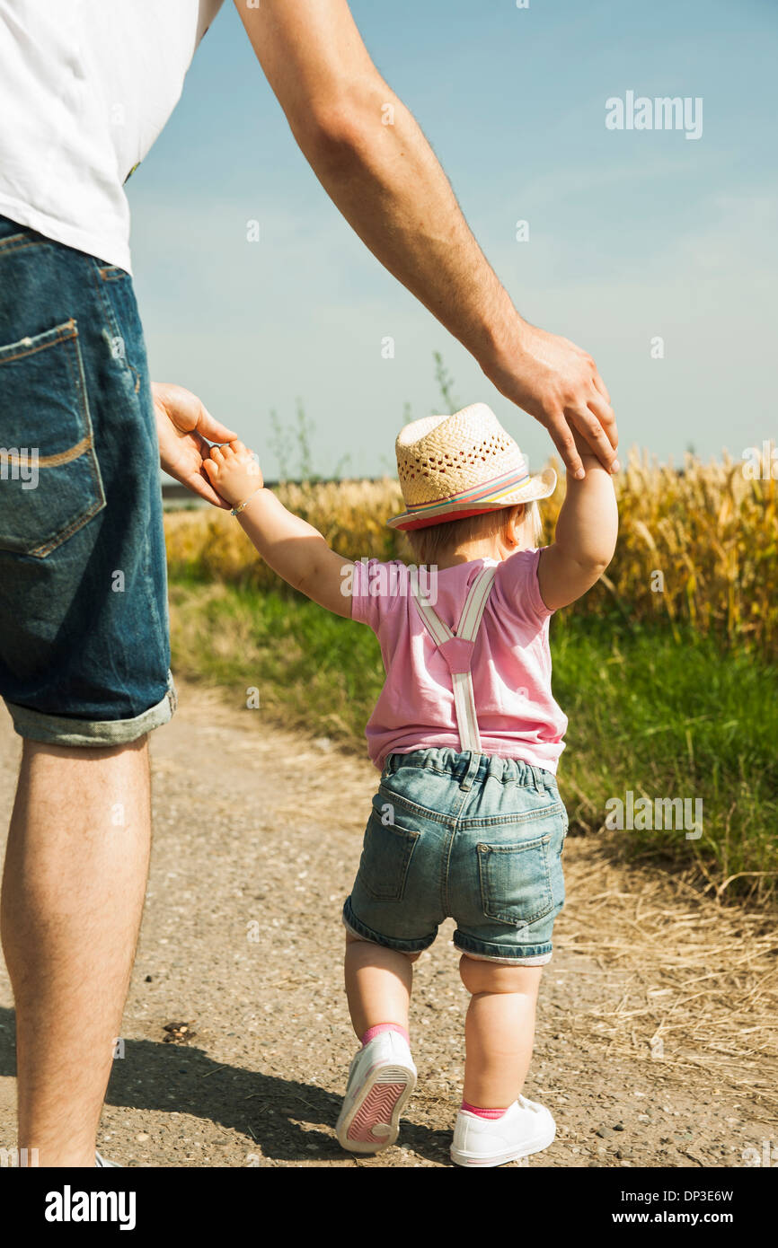 Father and Baby Daughter Walking Outdoors, Mannheim, Baden-Wurttemberg, Germany Stock Photo