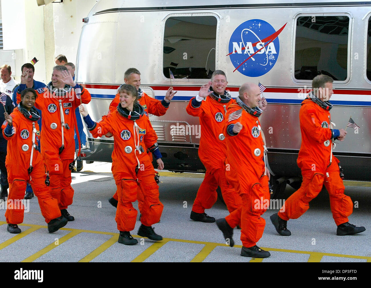 Jul 04, 2006; Cape Canaveral, FL, USA; Space shuttle Discovery crew members walk out Tuesday morning waving American and German flags on their way to the space craft at Kennedy Space Center. (L-R) Mission Specialists Astronauts STEPHANIE WILSON, THOMAS REITER of Germany, LISA NOWAK and PIERS SELLERS, Pilot MARK KELLY, Mission Specialist MICHAEL FOSSUM and commander STEVEN LINDSEY.  Stock Photo