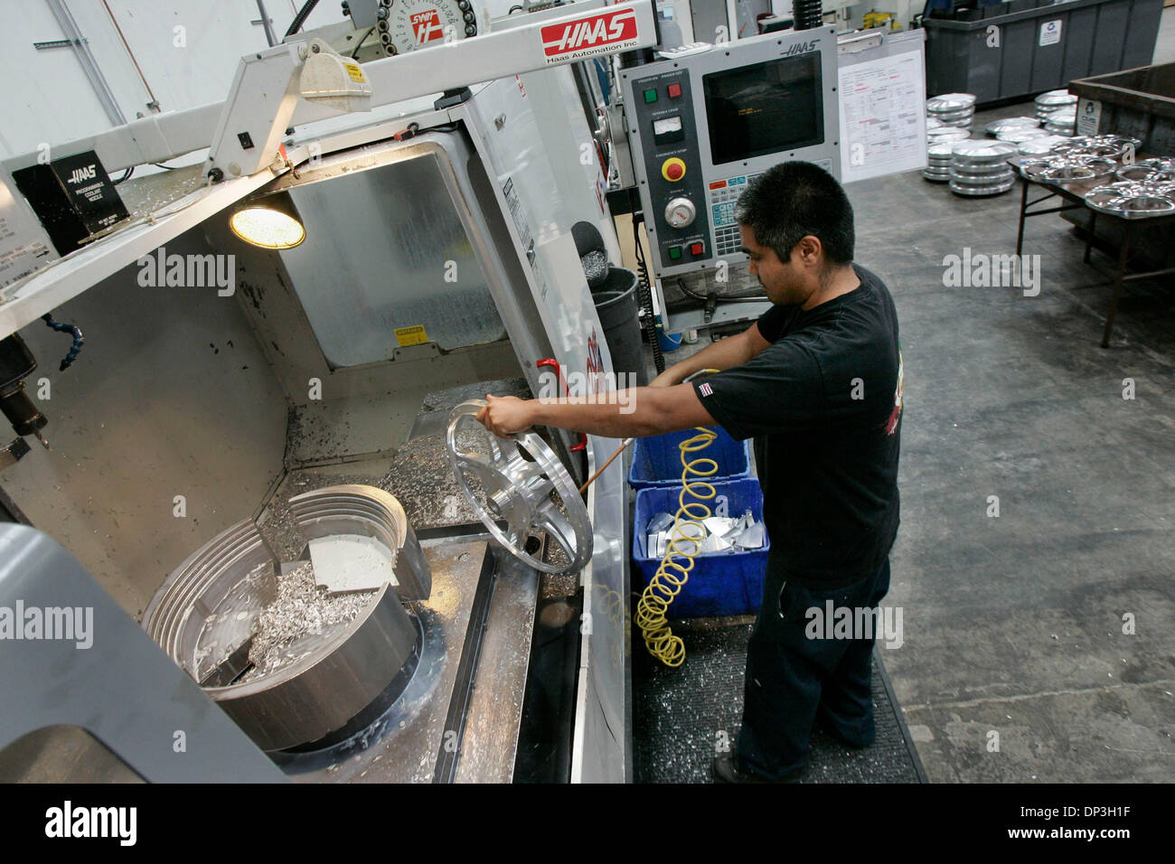 Jul 07, 2006; Vista, CA, USA; Machinist GUY ABADILLA blows off a newly