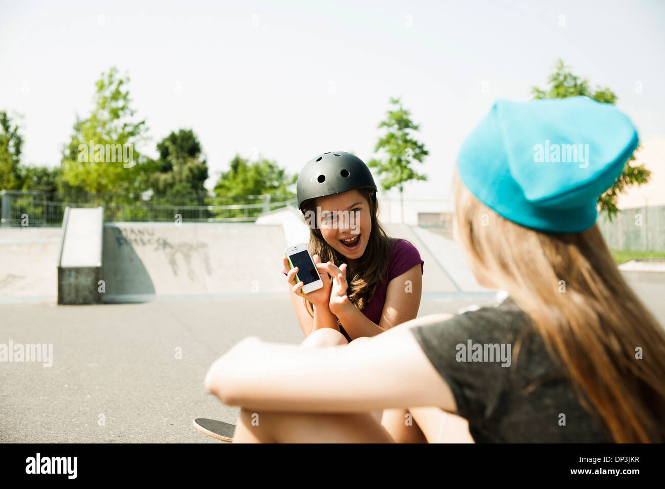 Girls in Skatepark with Smartphone, Feudenheim, Mannheim, Baden-Wurttemberg, Germany Stock Photo