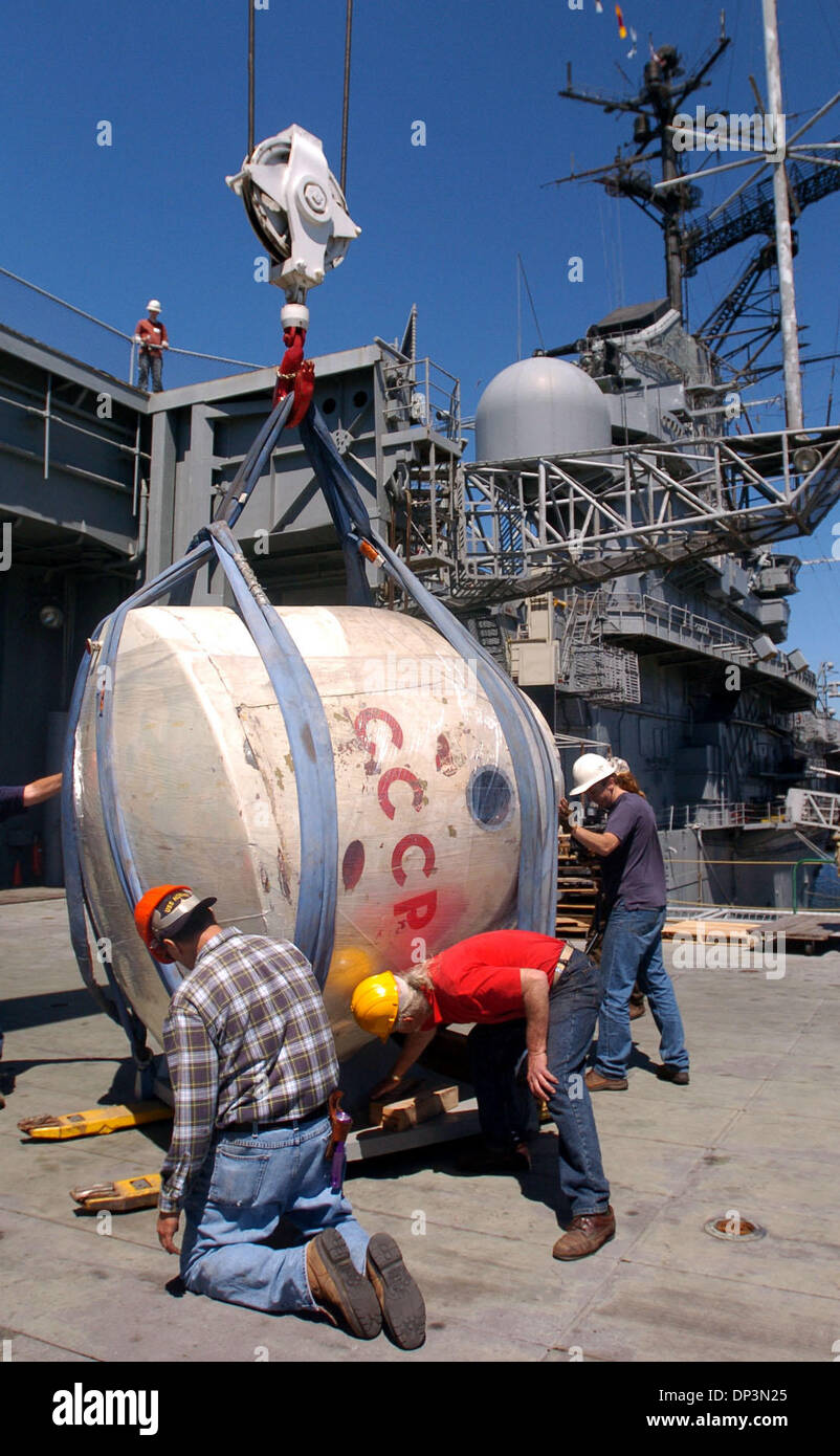 Jul 12, 2006; Alameda, CA, USA; The crew from the USS Hornet move the Soyuz 7K-0K, which is dated between 1967 and 1971, onboard where it will sit next to an Apollo capsule. The three-seat Soyuz is part of the Chabot space collection and is being put on display in an effort to raise funds to restore the capsule. The capsule has a fully intact instrument panel and a thruster engine  Stock Photo