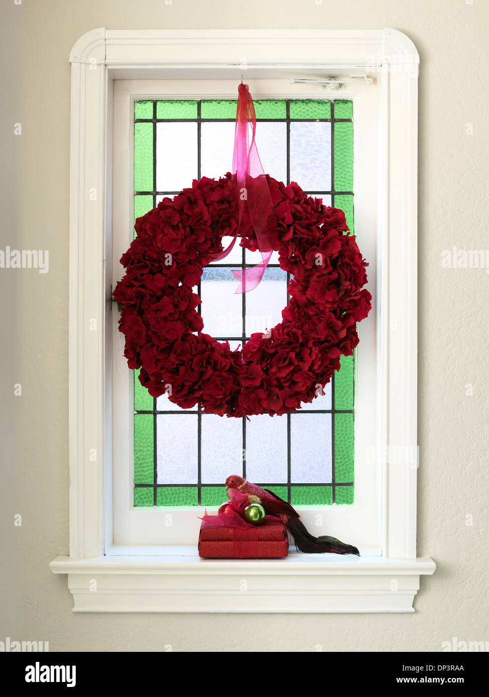 Window Decorated with Christmas Wreath and Gift Stock Photo