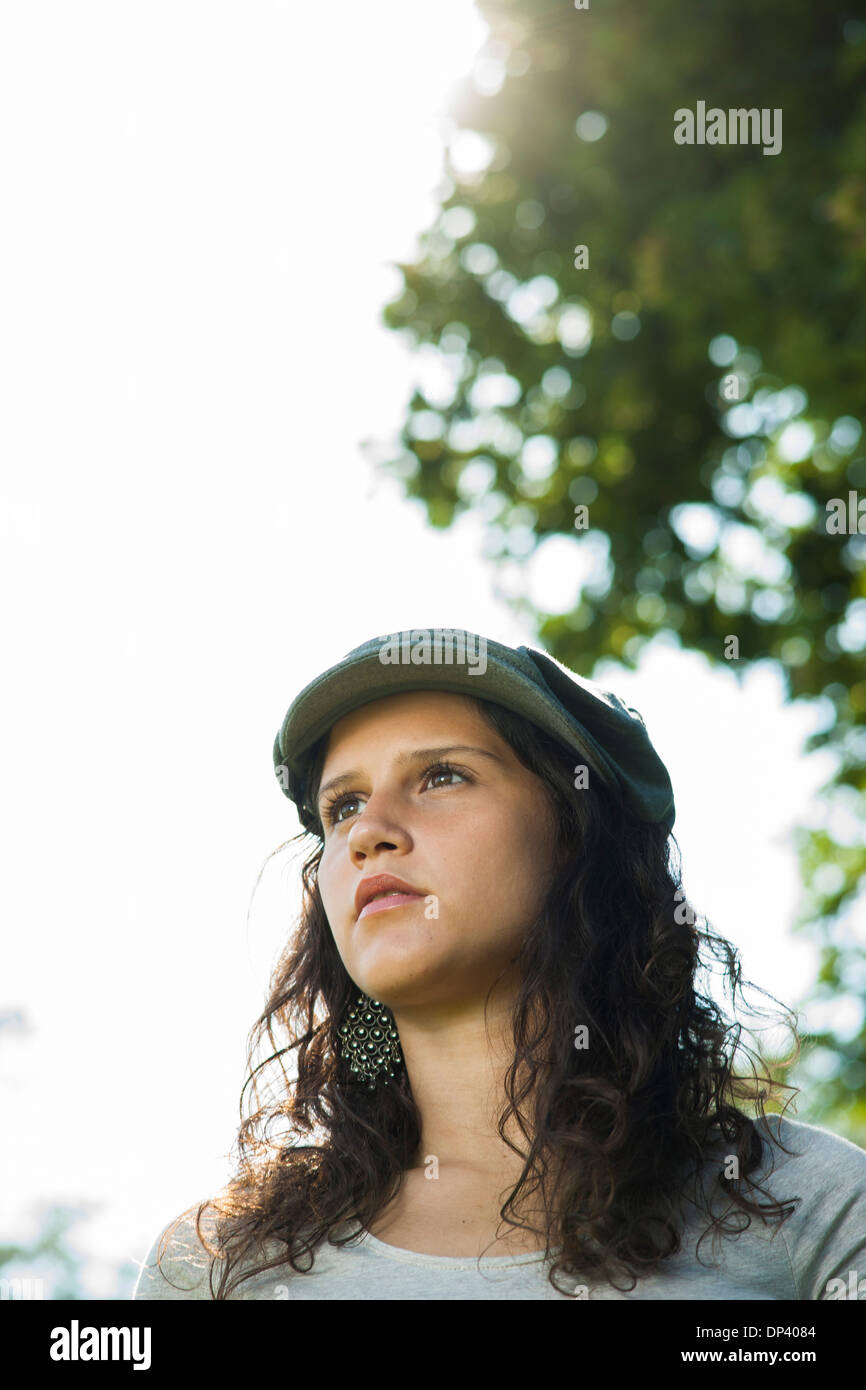 Close-up portrait of teenaged girl wearing cap outdoors, looking into the distance, Germany Stock Photo