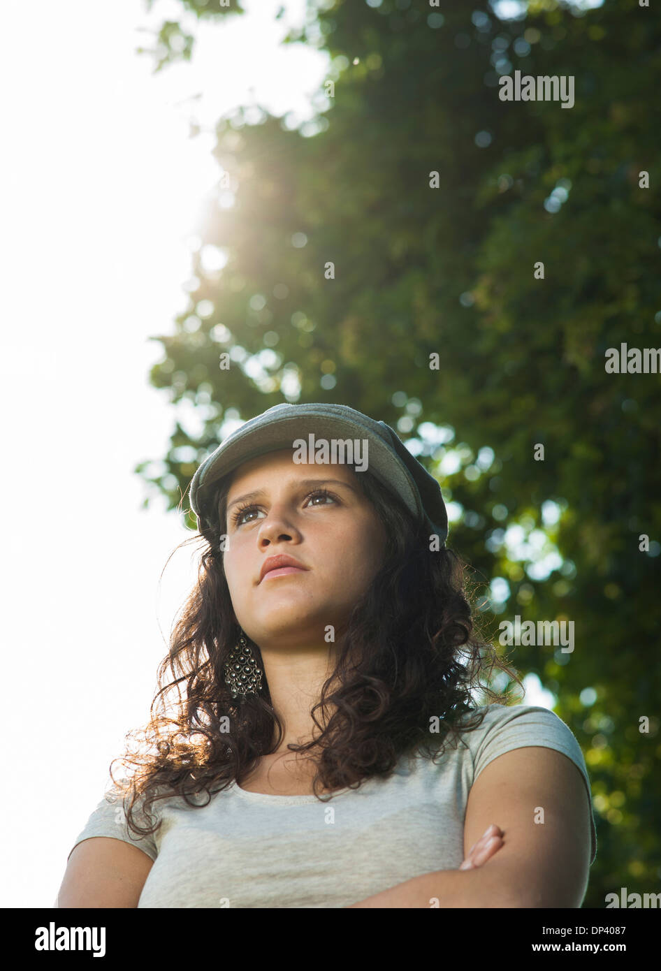 Close-up portrait of teenaged girl wearing cap outdoors, looking into the distance, Germany Stock Photo