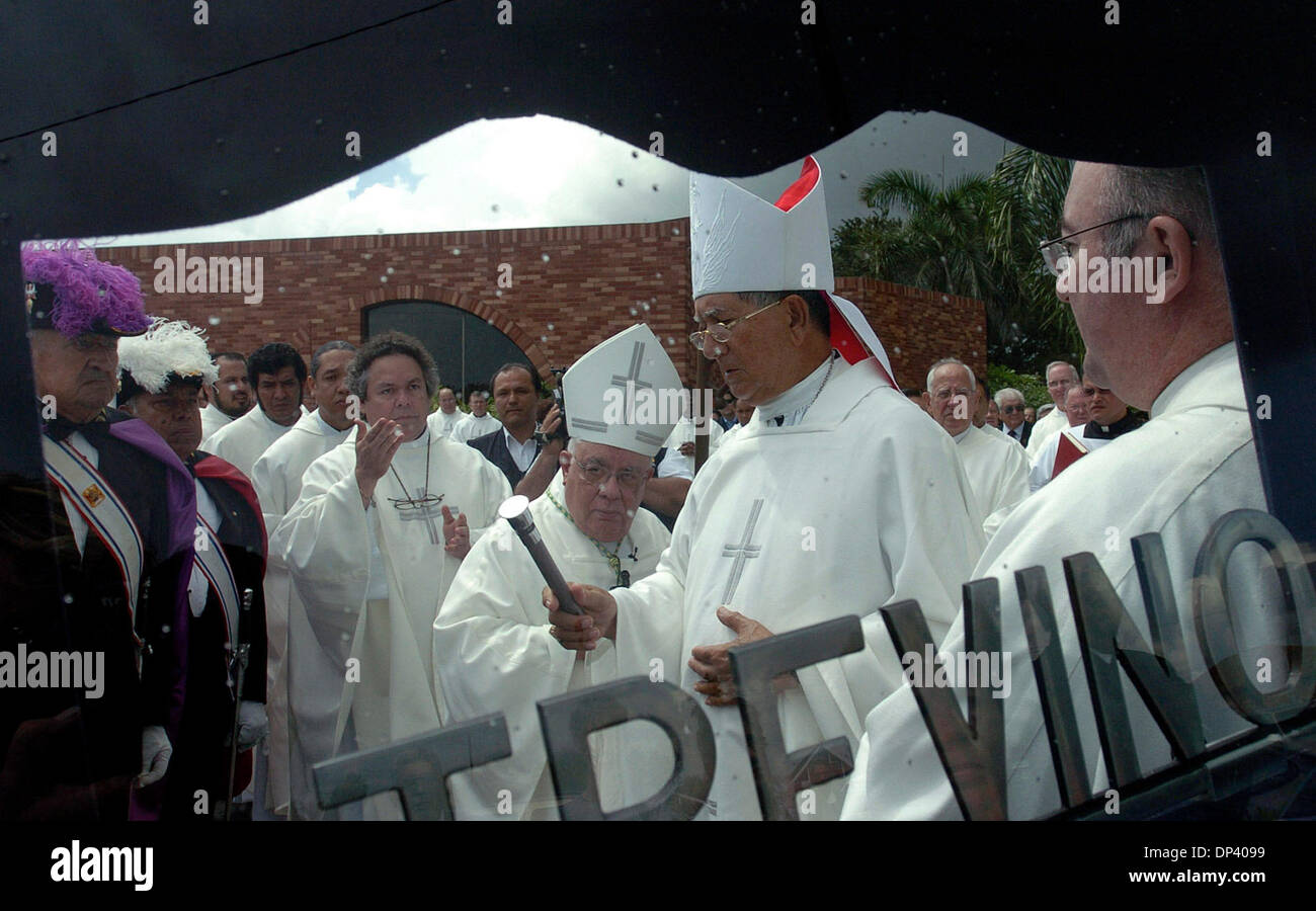 Jul 19, 2006; Brownsville, TX, USA; As clouds darken and a faint drizzle fell,priests and bishop from the valley and state gather at the foot of the door to the hearse with the late Bishop John J. Fitzpatrick body lay to sprinkle holy water and pay their last respects. Mandatory Credit: Photo by Delcia Lopez/San Antonio Express-News/ZUMA Press. (©) Copyright 2006 by San Antonio Exp Stock Photo