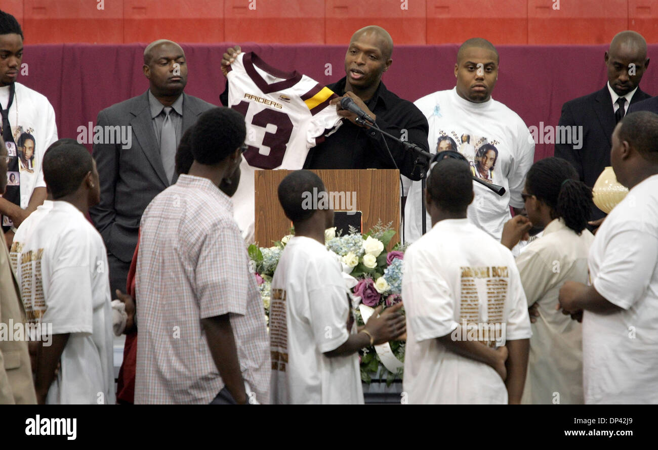 Jul 22, 2006; Belle Glade, FL, USA; Mae Delores Glades Central football coach Willie Snead holds up the #13 jersey worn by  Stanfield S. Watson, Jr. at away games during the funeral service. The Raiders will retire the #13 road jersey and give it to his family. Watson was killed in a car crash last Sunday. The funeral service was held in the gym at Glade Central Community High Scho Stock Photo