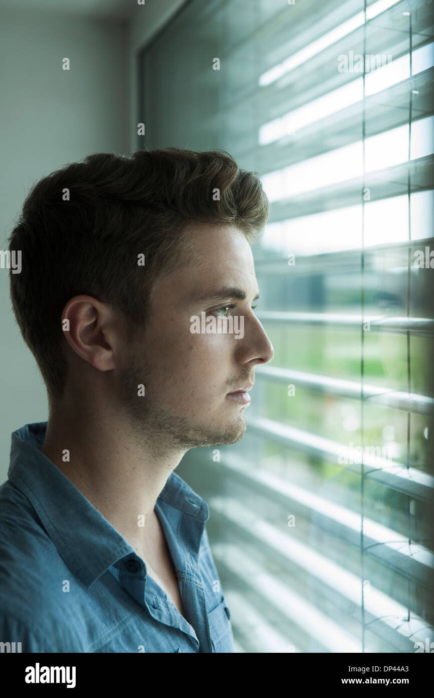 Man looking out of window - Stock Image - F009/8001 - Science