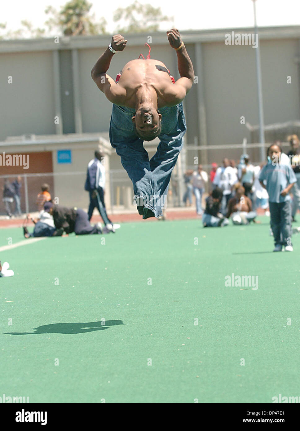 Jul 29, 2006; San Pablo, CA, USA; JESUS EL-LAZARD, 19, does a back flip during the BSAA (Black Sports Agents Association) sports and dance clinic at Contra Costa College. The clinic, thrown by Andre Farr, a former Kennedy High School and UCLA football player, featured motivational speakers and professional coaches giving instruction in basketball, football and dance among others. T Stock Photo