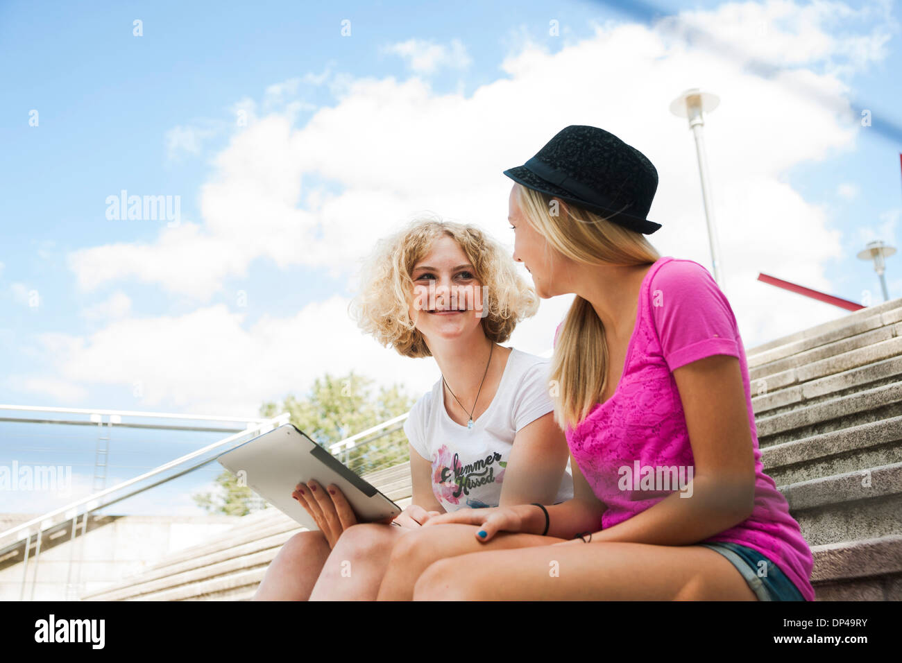 Two girls sitting on stairs hi-res stock photography and images - Alamy
