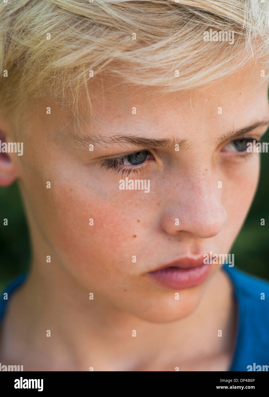 Close-up of boy outdoors, looking into the distance, Germany Stock Photo
