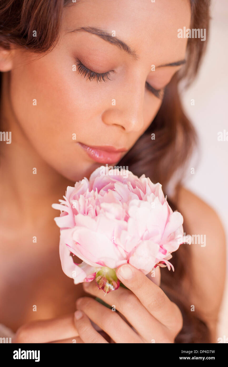 Woman smelling a flower Stock Photo