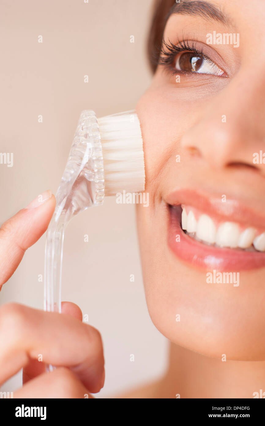 Woman exfoliating her face Stock Photo