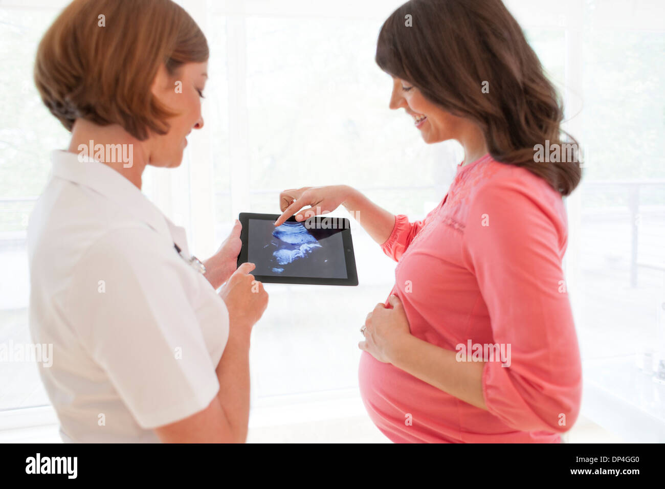 Pregnant woman with baby scan Stock Photo