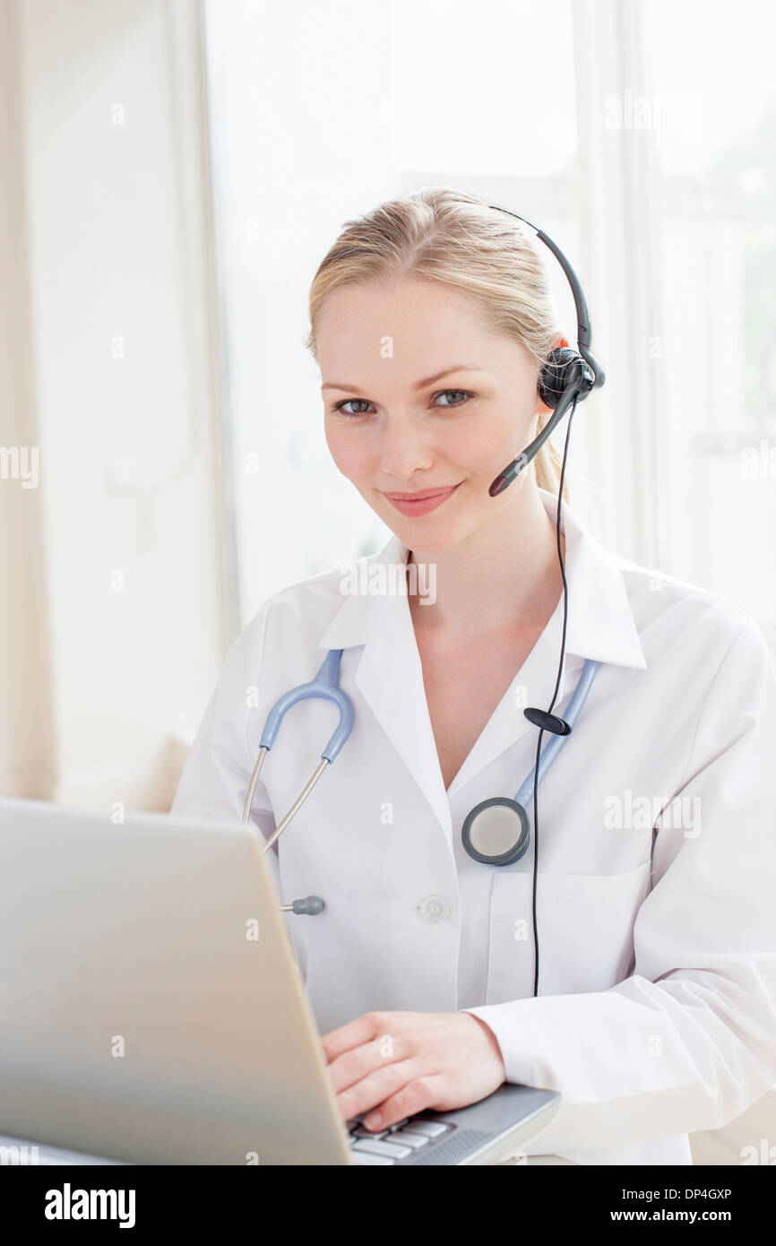 Doctor using a laptop computer Stock Photo