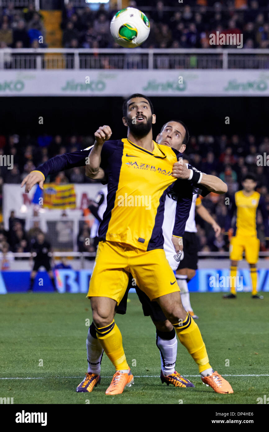 Valencia, Spain. 07th Jan, 2014. Midfielder Arda Turan of Atletico Madrid (L) challenges for the ball with Defender Joao Pereira of Valencia CF during the Copa del Rey Game between Valencia and Atletico de Madrid at Mestalla Stadium, Valencia Credit:  Action Plus Sports/Alamy Live News Stock Photo