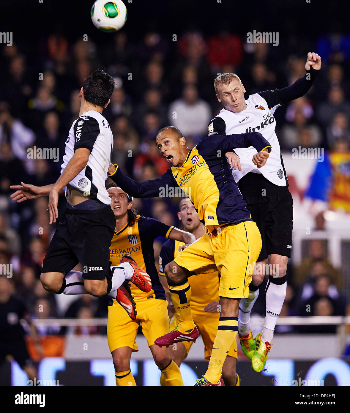Valencia, Spain. 07th Jan, 2014. Defender Joao Miranda of Atletico Madrid (2ndR) challenges for a high ball with Defender Jeremy Mathieu of Valencia CF (R) during the Copa del Rey Game between Valencia and Atletico de Madrid at Mestalla Stadium, Valencia Credit:  Action Plus Sports/Alamy Live News Stock Photo