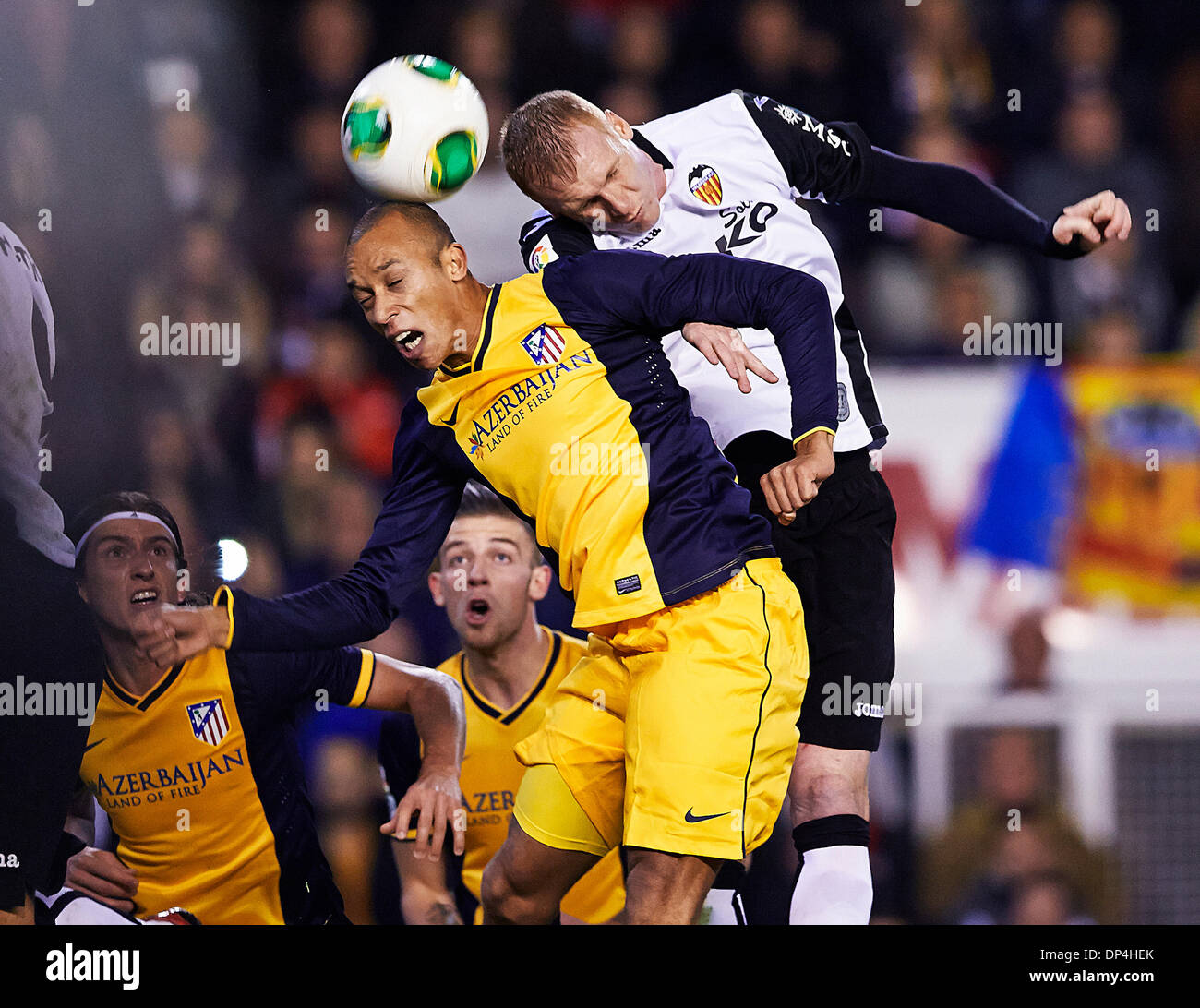 Valencia, Spain. 07th Jan, 2014. Defender Joao Miranda of Atletico Madrid (L) challenges for a high ball with Defender Jeremy Mathieu of Valencia CF (R) during the Copa del Rey Game between Valencia and Atletico de Madrid at Mestalla Stadium, Valencia Credit:  Action Plus Sports/Alamy Live News Stock Photo