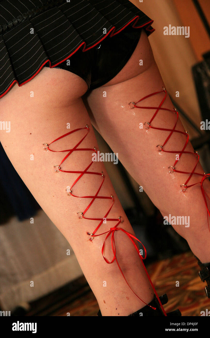 Aug 13, 2006; Tampa, FL, USA; Audra from Z-Edge Tattoos and Body Piercing  gets 20 piercings (10 on the back of each leg) to create a human flesh  corset on the back