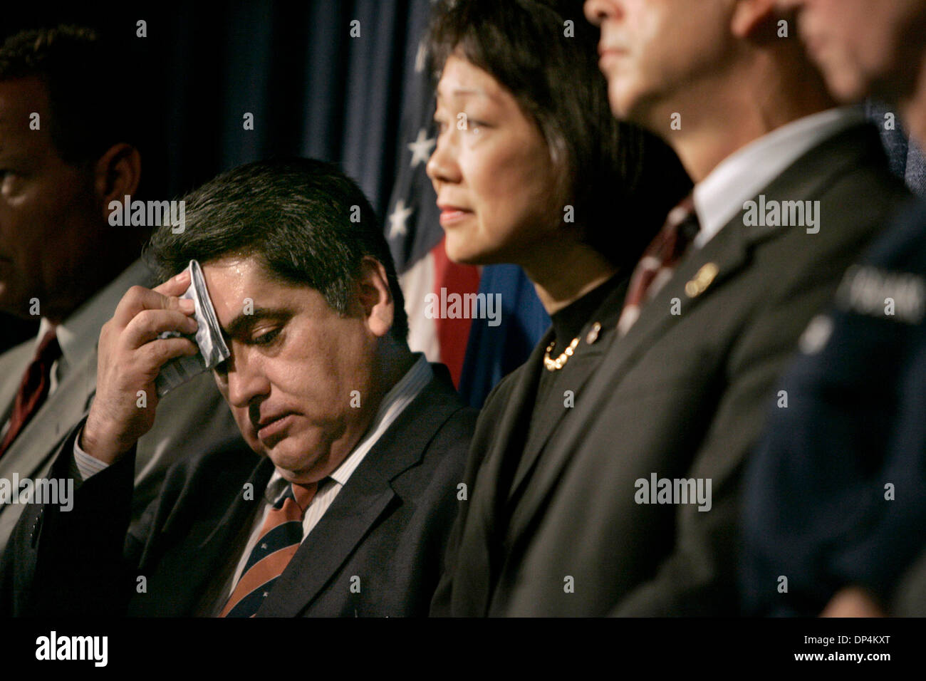 Aug 17, 2006; San Diego, CA, USA; Mexico's Deputy Attorney General JOSE LUIS SANTIAGO VASCONCELOS, left, wipes his brow as he, US Attorney CAROL LAM and other Mexican and US officials answer reporters questions at a press conference discussing the arrest on Monday August 14, 2006 in international waters off Baja California of  Francisco Javier Arellano Felix, the kingpin of the Are Stock Photo