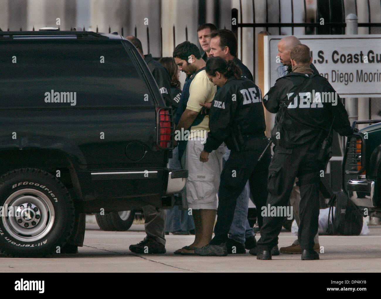 Aug 17, 2006; San Diego, CA, USA; An Alleged suspect in the Arellano-Felix drug cartel is taken from a US Coast Guard vessel to a waiting DEA SUV at the San Diego Coast Guard Station. The suspects, as many as 11 were arrested in international waters off the coast of Baja California on Monday August 14, 2006 while they were deep-sea fishing. Those arrested included Francisco Javier  Stock Photo