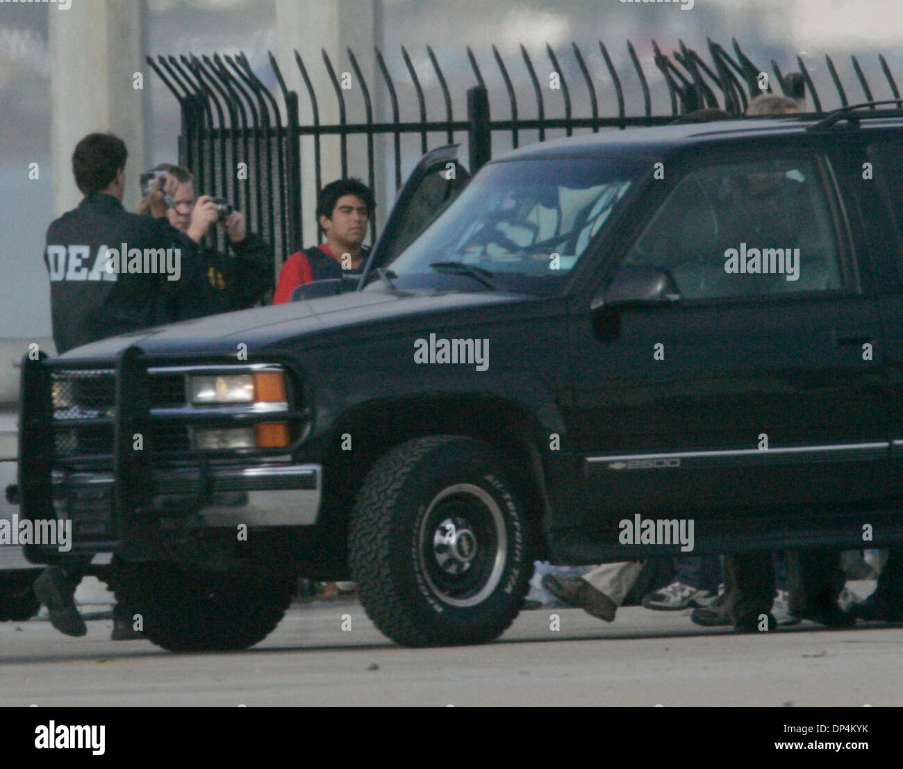 Aug 17, 2006; San Diego, CA, USA; Alledged members of the Arellano-Felix drug cartel were taken from a Coast Guard vessel and put into waiting SUV's to be taken to the Federal Courthouse in San Diego to be arraigned August 17, 2006.  They were apprehended off the coast of Baja California, Mexico, in international waters on Monday, August 14, 2006.  Suspect is in body aromor and wea Stock Photo