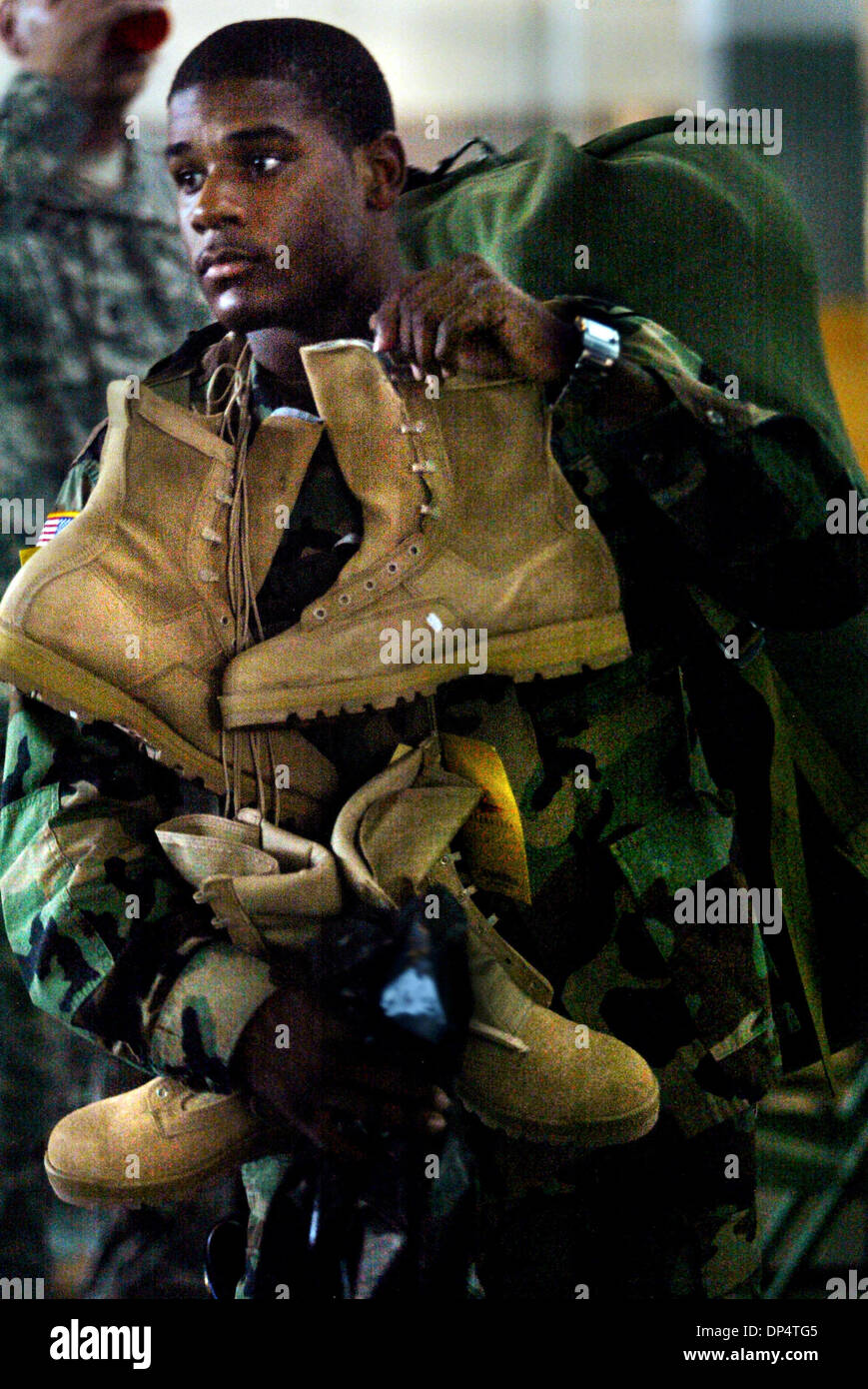 Aug 23, 2006; Ft. Pierce, FL, USA; Spc. Antonio McNutt carries in extra boots following Wedensday's deployment ceremony at the the Armory on Delaware Ave  in Ft. Pierce.  Mandatory Credit: Photo by Amanda Voisard/Palm Beach Post/ZUMA Press. (©) Copyright 2006 by Palm Beach Post Stock Photo