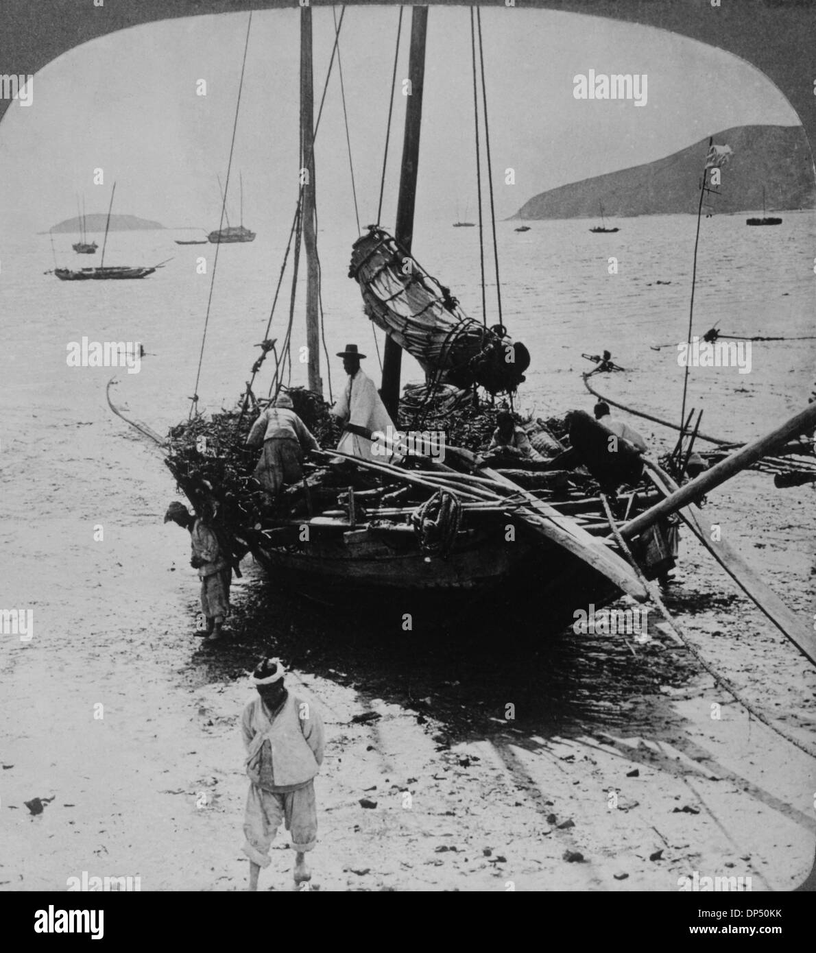 Coolies Unloading Boat at Low Tide, Kowloon, Hong Kong, 1910 Stock Photo