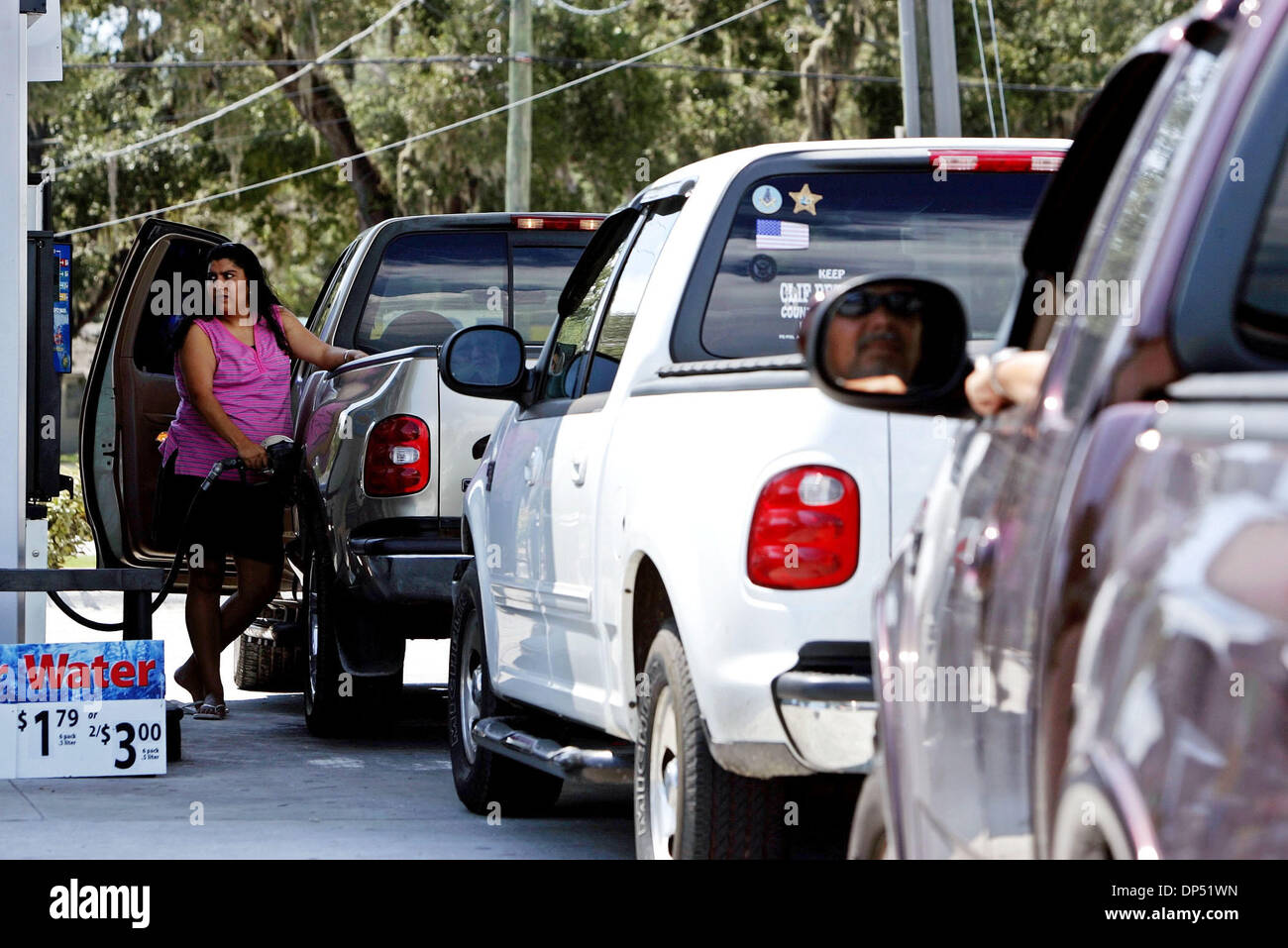 Aug 28, 2006; Okeechobee, FL, USA; Residents and businesses prepare for Hurricane Ernesto. As several trucks wait in line for gas, Isabel Ramos, 26, of Okeechobee pumps her truck full of gas at Murphy USA in Okeechobee Monday afternoon. She's nervous because she'll be staying in her mobile home for the storm.  Mandatory Credit: Photo by Libby Volgyes/Palm Beach Post/ZUMA Press. (©) Stock Photo