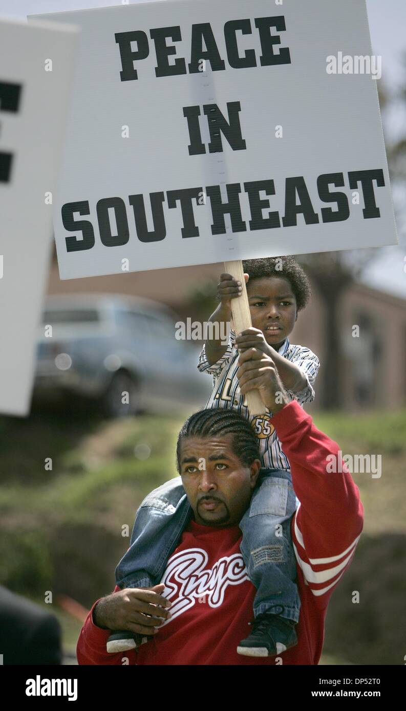 (Published 4/9/2005, B-3:1, B-7:6, B-10:7)  Travis Stocking carries four-year-old Enrique Stocking during a peace march with other community members and students from Grompers Middle School to call for the end to gang violence in the Lincoln Park area of San Diego. Earnie Grafton/UT Stock Photo