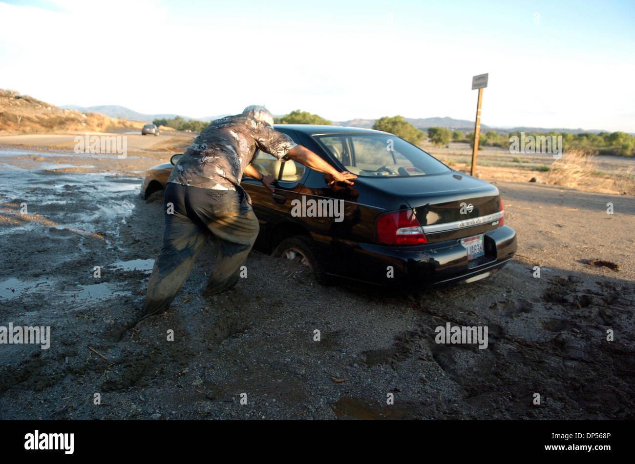 Sep 04, 2006; San Jacinto, CA, USA; Pat Maresca attempts to rescue his vehicle that was washed away in a mudslide along Soboba Road in San Jacinto on Monday. Multiple mudslides caused by heavy rain from a thunderstorm caused a mountain side to give way trapping 19 motorists along the roadway.  There were no reported injuries. Mandatory Credit: Photo by Steven K. Doi/ZUMA Press. (©) Stock Photo