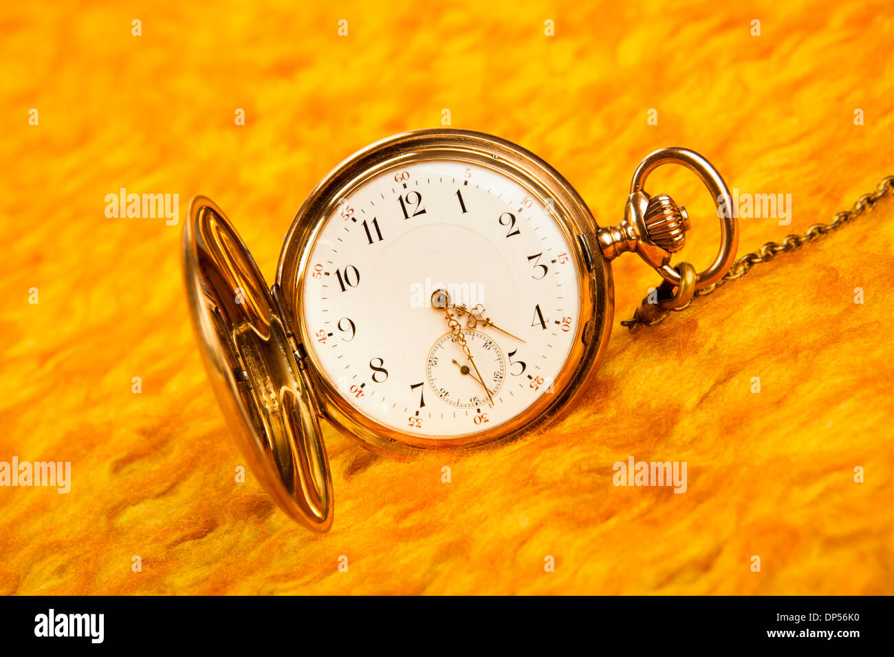 Gold pocket watch on on gold cover closeup Stock Photo Alamy