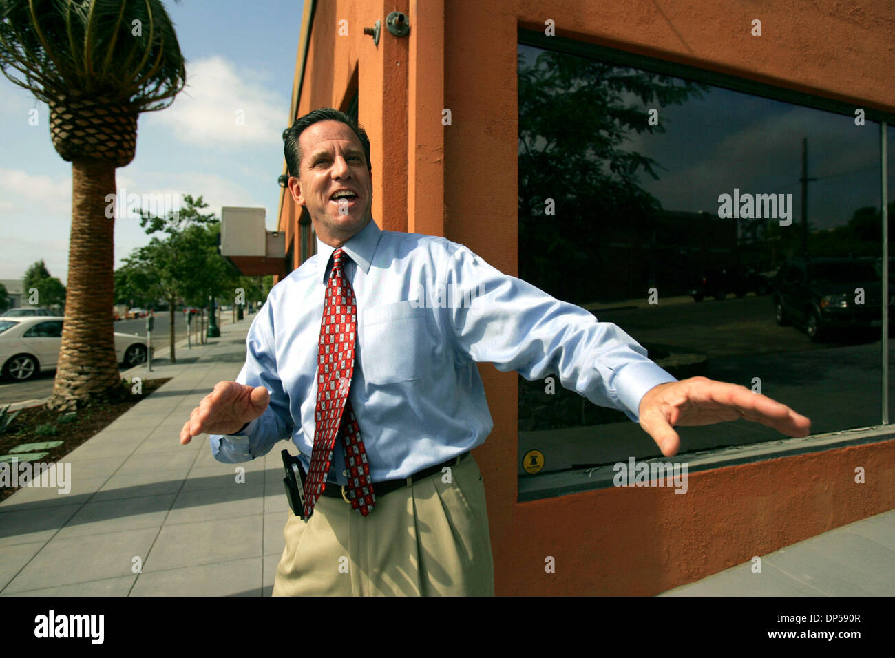 Sep 07, 2006; San Diego, CA, USA; DAVID PECKINPAUGH, president and CEO of  the San Diego Convention and Visitors Bureau, jokes with passerbys in front  of the bureau's new accommodations on India