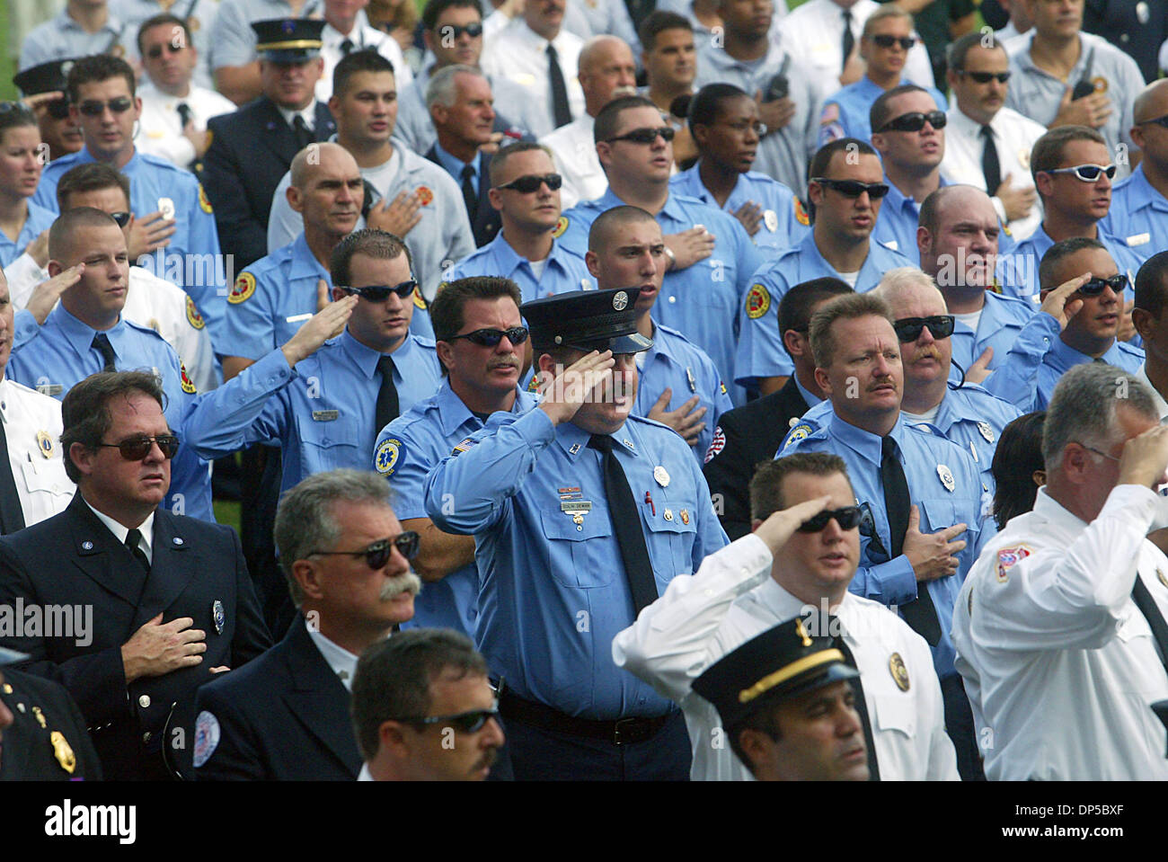 Sep 11, 2006; West Palm Beach, FL, USA; Emergency rescue officials salute during memorial held at the Meyer Amphitheater Monday morning.  Firefighters from across southern Florida joined together at the Meyer Amphitheater to 'never forget' and honor the 343 firefighters who died on September 11, 2001. The event was sponsored by Fire chiefs of Palm Beach County and Palm Beach County Stock Photo