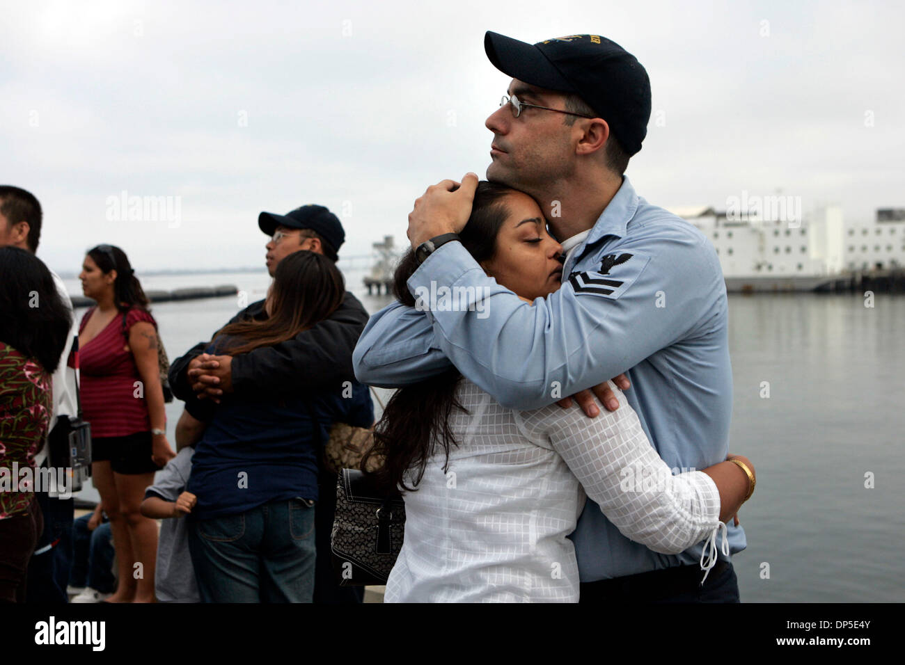 Sep 13, 2006; San Diego, CA, USA; BRYAN ENCINAS, age 31, embraces his girlfriend, JASPREET MARWAHA as they say goodbye before ENCINAS's deployment on the USS Boxer early Wednesday morning.  Eight ships, six of them from San Diego, left Wednesday for a six-month West Pac deployment that could take them to the Persian Gulf.  They are:  the 15th Marine Expeditionary Unit, the USS Boxe Stock Photo