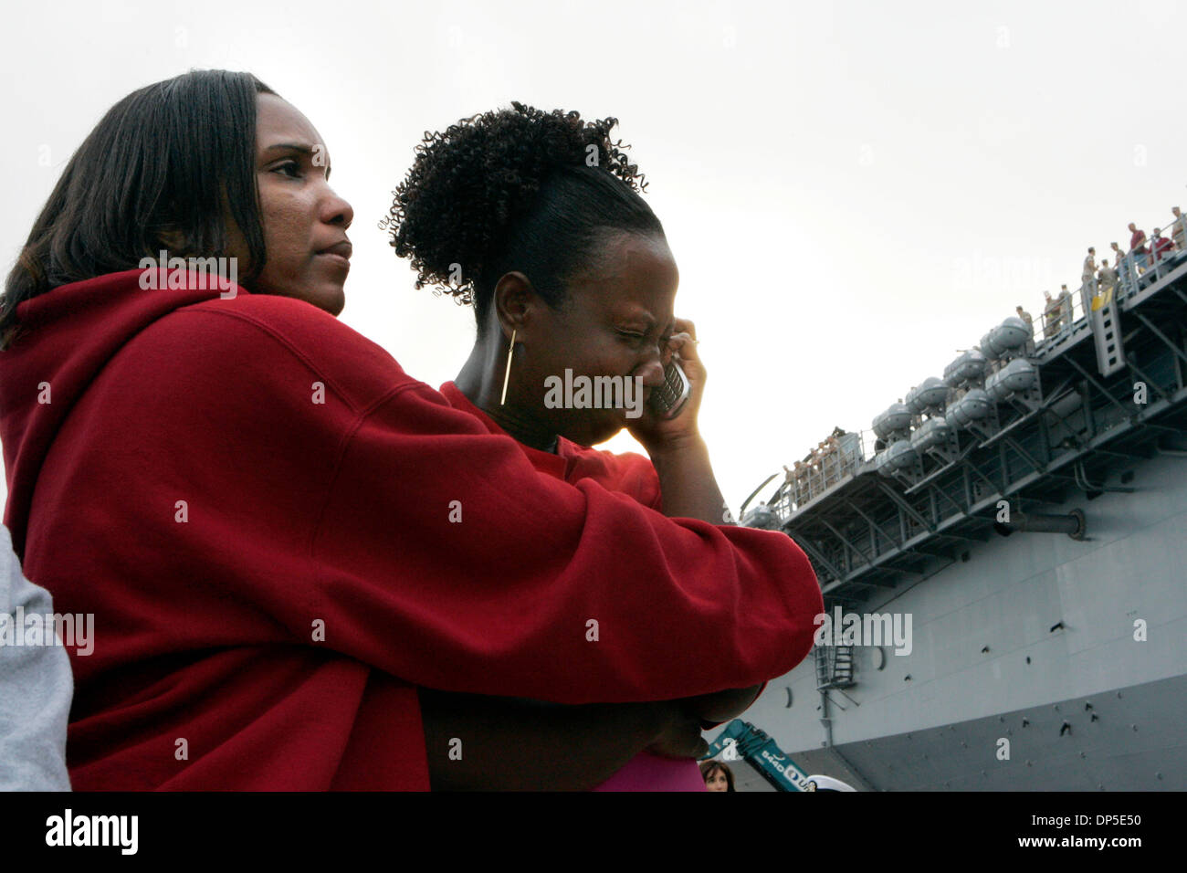 Sep 13, 2006; San Diego, CA, USA; ROSETTA SOLOMON, left, soothes her friend, MONIQUE WHITE, as both their husbands deployed on the USS Boxer early Wednesday morning.  Both are from Temecula.  Eight ships, six of them from San Diego, left Wednesday for a six-month West Pac deployment that could take them to the Persian Gulf.  They are:  the 15th Marine Expeditionary Unit, the USS Bo Stock Photo