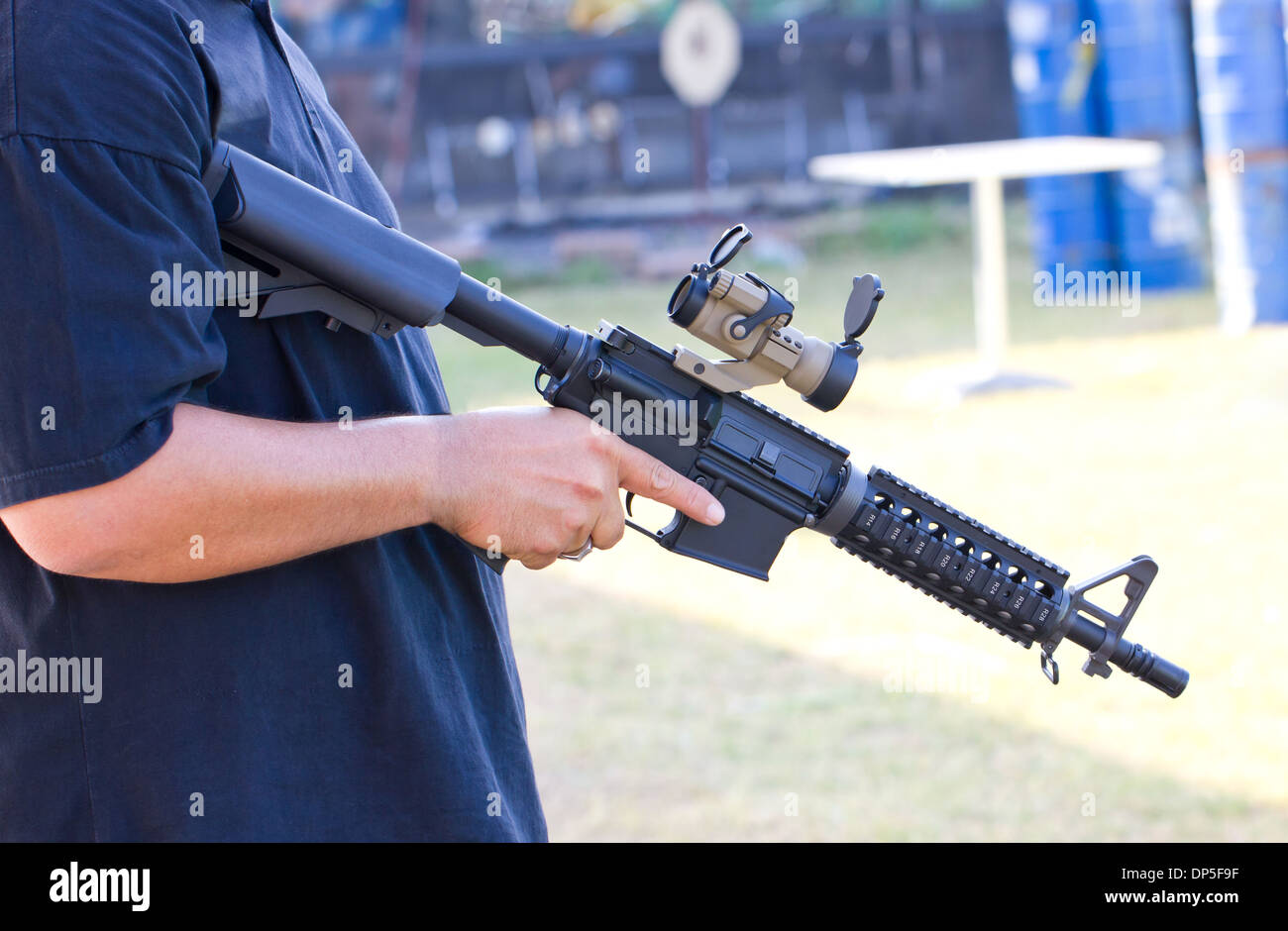 Air gun in Asian man's hand Stock Photo Alamy