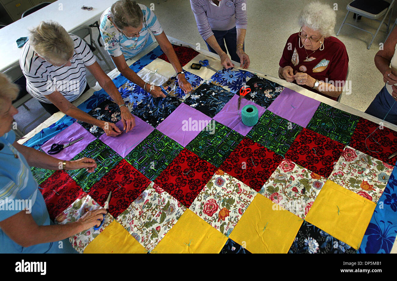 Sep 19, 2006; Port St. Lucie, FL, USA; As part of the Lutheran World Relief effort, the 'Women at St. Andrew's'  work together every week at the church parish hall to assemble colorful tied twin-size coverlet quilts for donation to needy people around the world.  The group of women, which numbers about a dozen in total (7 were present  tuesday) make over 100 quilts every year from  Stock Photo