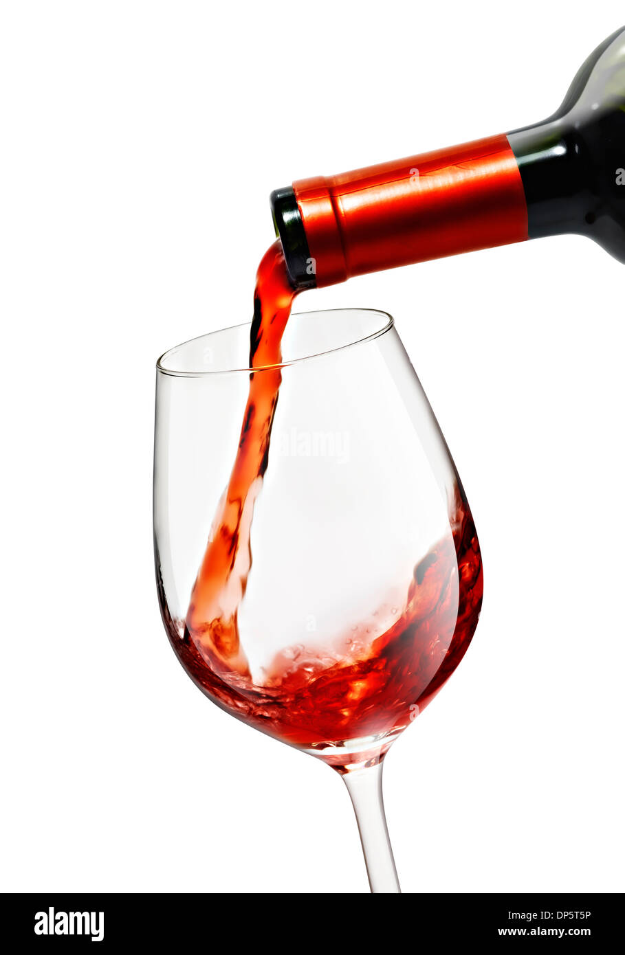 Pouring red wine in a wine glass with a nice reflection and wine bottle