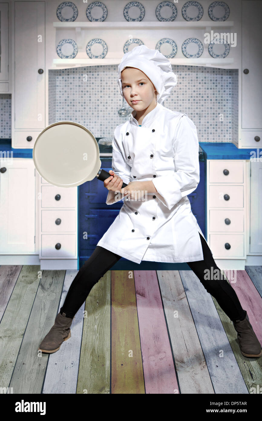 young female cook with a frying pan and egg Stock Photo