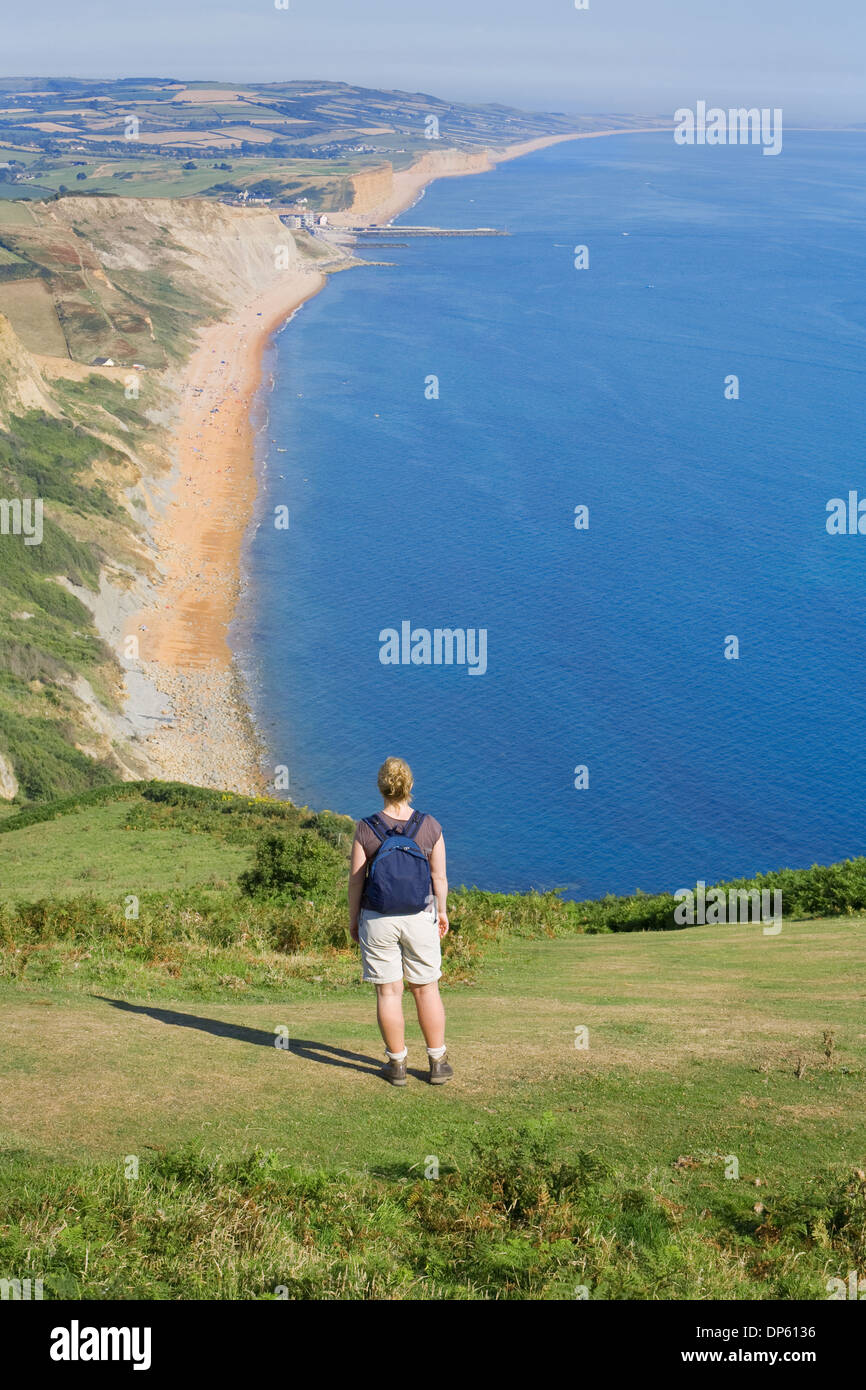 Female walker takes in the stunning views of the Dorset coastline and countryside. Stock Photo