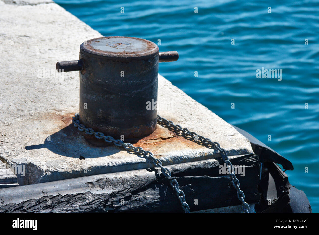 Mooring Bollard with chain on pier Stock Photo