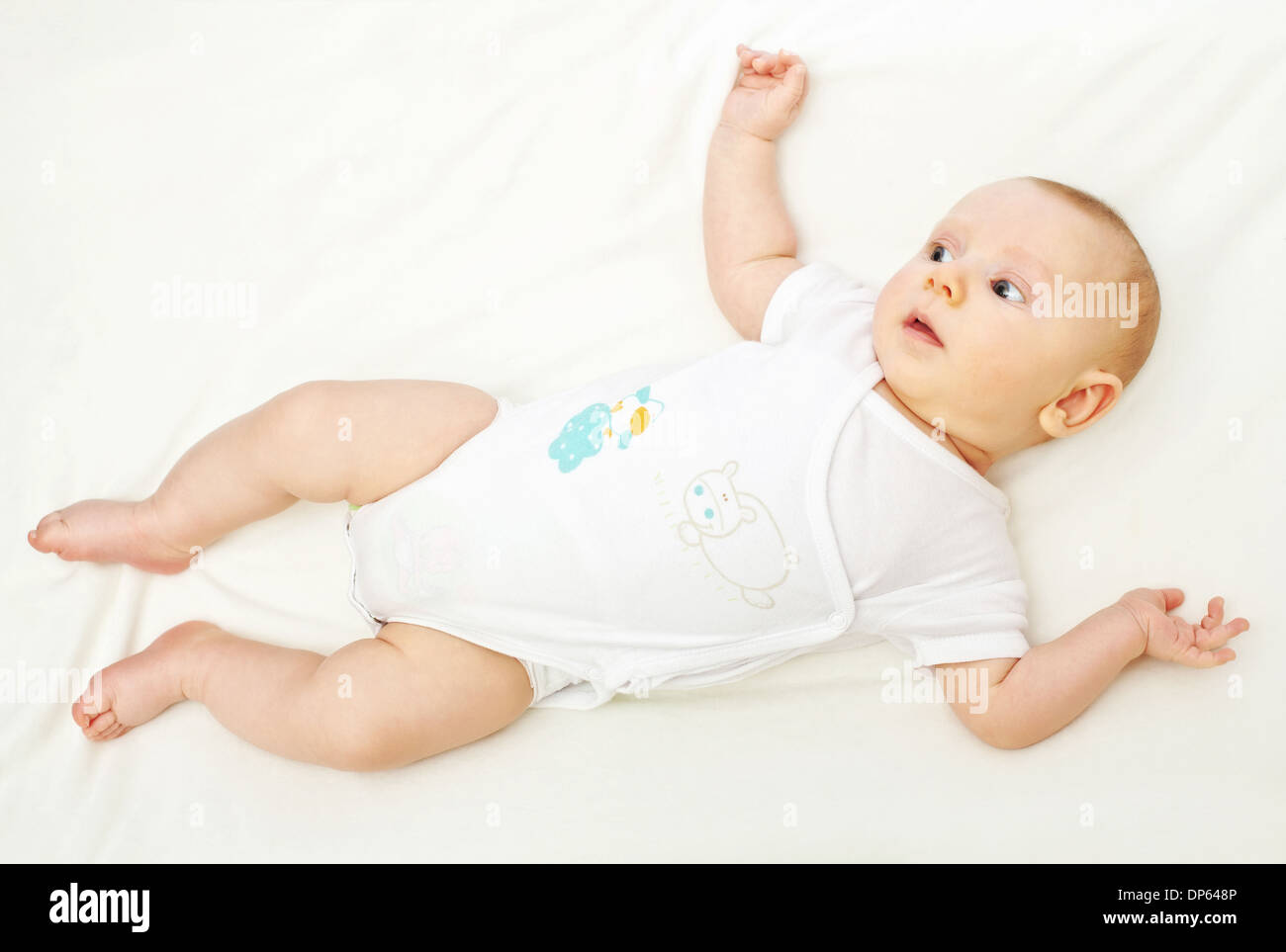 portrait of young baby on white blanket Stock Photo