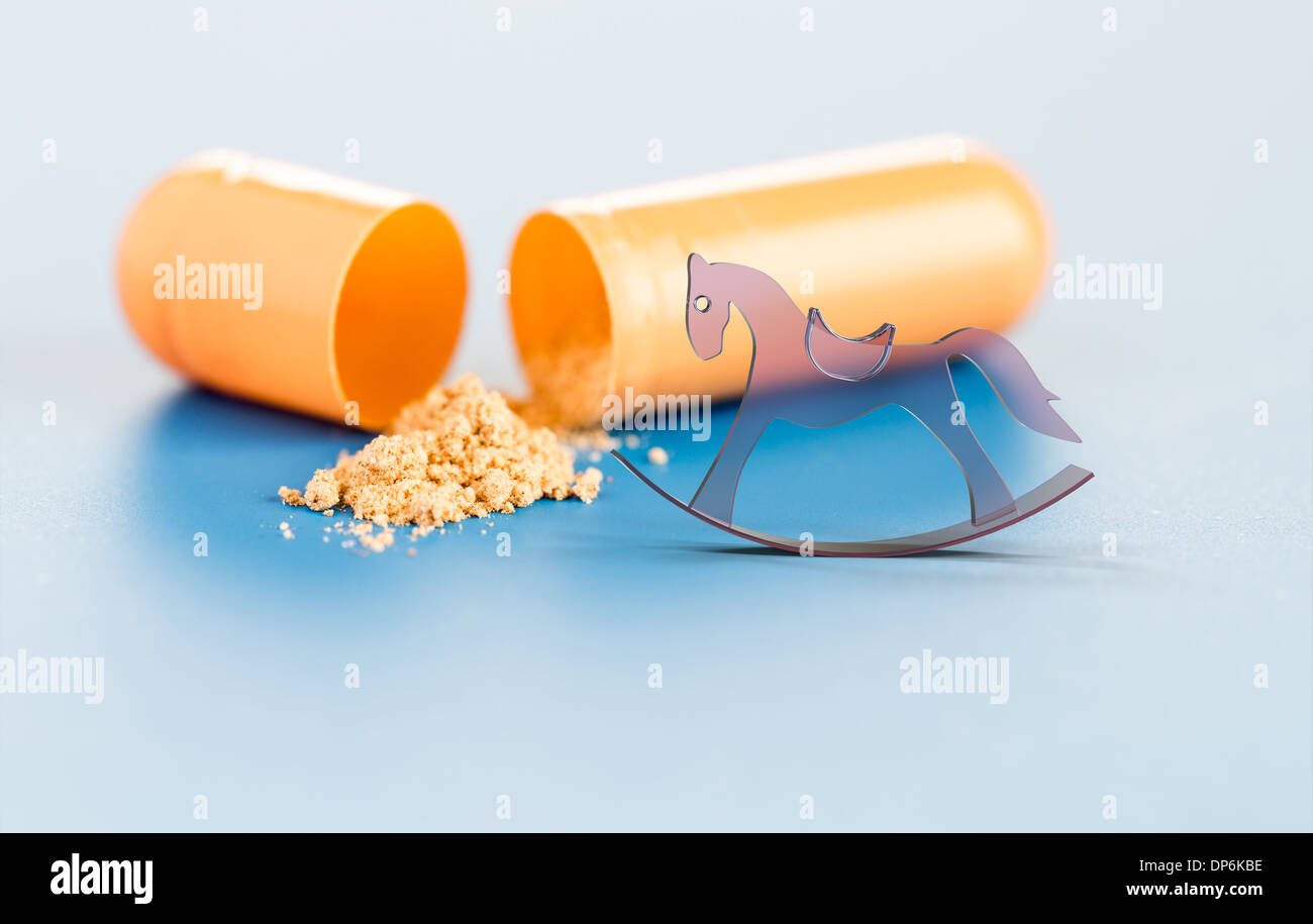 vitamins in capsules and toy horse Stock Photo