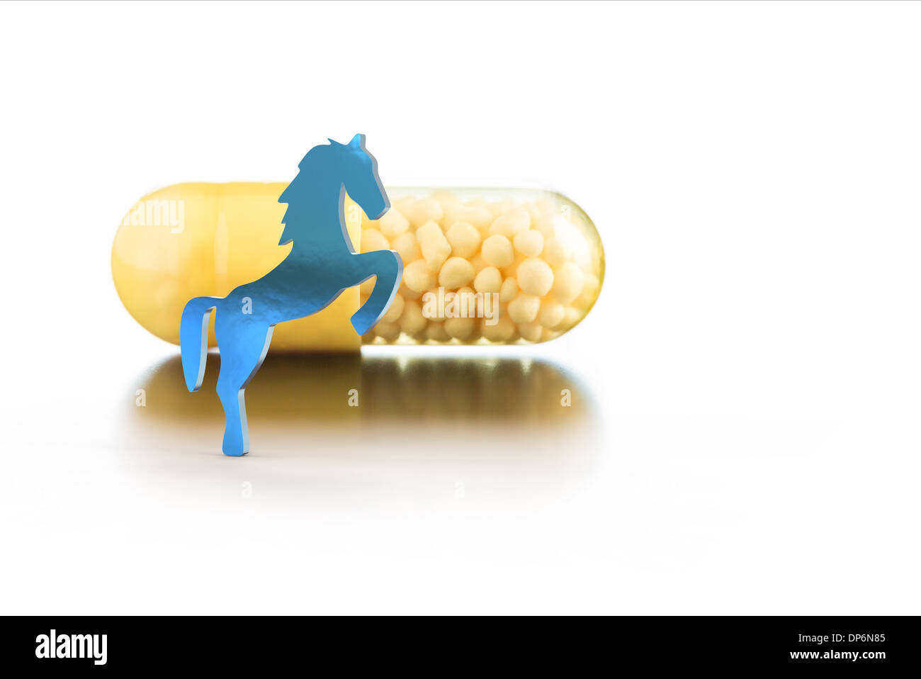 vitamins in capsules and toy horse Stock Photo