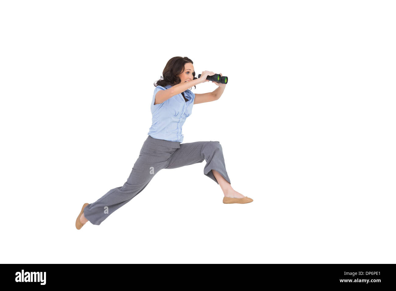 Cheerful classy businesswoman jumping while holding binoculars Stock Photo